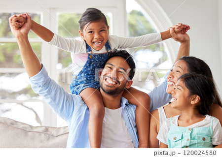 Parents, girl children and piggyback in home with bonding, fun game and support with love, security and excited. Family, couple and playing with kids on shoulders in living room for care or activity 120024580
