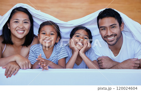 Family, portrait and blanket on bed with smile for relax, bonding and break on weekend together. Woman, father and child in home with love, care and support for comfort or happiness in Philippines Family, portrait and blanket on bed with smile for relax, bonding and break on weekend together. Woman, father and child in home with love, care and support for comfort or happiness in Philippines 120024604