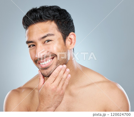 Portrait, skincare and smile of masculine man in studio on gray background for cosmetic wellness. Beauty, dermatology and natural with face of confident person in bathroom for hydration or hygiene Portrait, skincare and smile of masculine man in studio on gray background for cosmetic wellness. Beauty, dermatology and natural with face of confident person in bathroom for hydration or hygiene 120024700