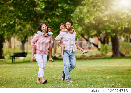 Family, park and walking with piggy back for wellness or happiness, together in nature for bonding. Mixed race people, children and parents on grass for vacation in Europe, smile for travel with kids Family, park and walking with piggy back for wellness or happiness, together in nature for bonding. Mixed race people, children and parents on grass for vacation in Europe, smile for travel with kids 120024718