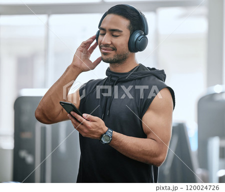 Music, headphones and man with cellphone in gym, athlete and ready for workout, fitness and training. Health club, guy and routine of exercise in morning, ambition and preparing of competition Music, headphones and man with cellphone in gym, athlete and ready for workout, fitness and training. Health club, guy and routine of exercise in morning, ambition and preparing of competition 120024726