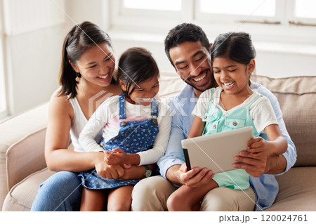 Happy family, entertainment and sofa with tablet for holiday, weekend or watching together at home. Mother, father and children with smile in joy for love, bonding or support on technology at house 120024761
