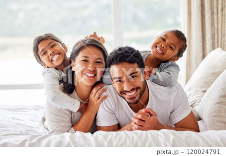 Family, portrait and hug on bed together, love and bonding for security in relationship. Parents, children and embrace kids or support on weekend, comfortable and happiness in bedroom of care in home 120024791