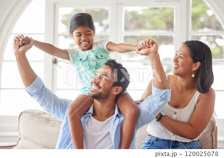 Parents, girl child and piggyback in home with bonding, fun game and support with love, security and excited. Family, couple and playing with daughter on shoulders in living room for care or activity Parents, girl child and piggyback in home with bonding, fun game and support with love, security and excited. Family, couple and playing with daughter on shoulders in living room for care or activity 120025078