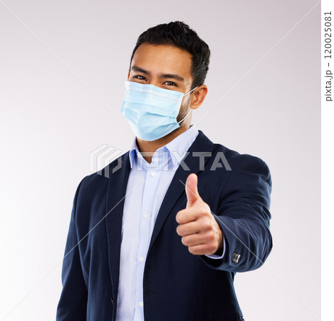 Mask, studio and portrait of businessman with thumbs up for healthcare, protection and good review. PPE, success and person with gesture of approval for LB.1, covid and safety on white background Mask, studio and portrait of businessman with thumbs up for healthcare, protection and good review. PPE, success and person with gesture of approval for LB.1, covid and safety on white background 120025081