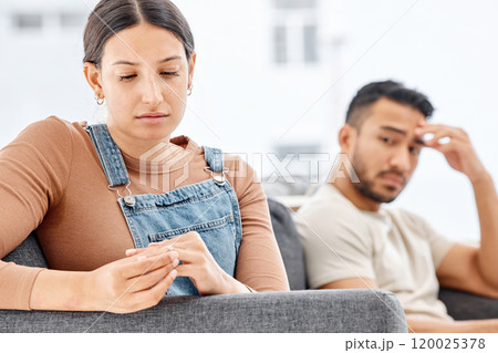Sad, woman and hands with wedding ring on sofa for conflict, separation or marriage crisis in living room. Doubt, anxiety and disappointed wife with man for divorce, infidelity or breakup in home 120025378