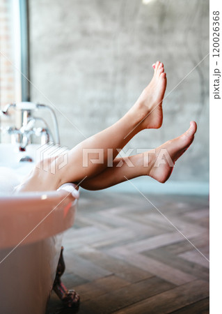Woman feet in bathrobe at home, closeup Woman feet in bathrobe at home, closeup 120026368