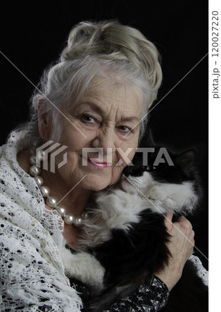 Portrait of an elderly woman with a black cat. 120027220