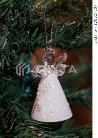 Glass angel ornament hanging on christmas tree. New Year 2025 120027507