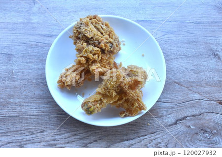 crispy fried salty chicken tight and leg with bread crumb and egg yolk on plate crispy fried salty chicken tight and leg with bread crumb and egg yolk on plate 120027932