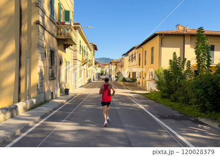 rear view runner running down street of Italian city half marathon race 120028379
