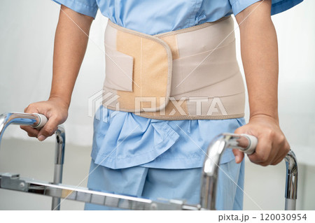 Asian senior pain back wearing elastic support belt with walker. Asian senior pain back wearing elastic support belt with walker. 120030954