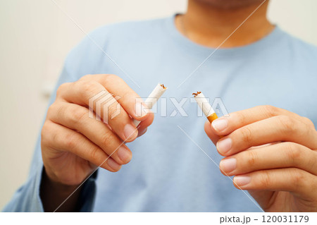 Quit smoking, Asian man breaking destroy cigarette in hand. Quit smoking, Asian man breaking destroy cigarette in hand. 120031179