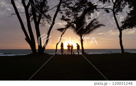 A fiery and vibrant sunset casts a mesmerizing and dramatic sky over the tranquil expanse of the sea, painting the horizon with stunning hues of orange, pink, and purple. 120031248