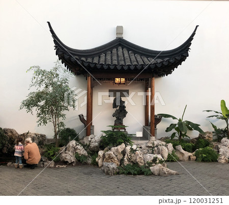 pagoda in Shanghai, China. A beautiful pagoda in Shanghai, China, surrounded by lush greenery and set against a serene backdrop, exuding traditional charm and tranquility 120031251