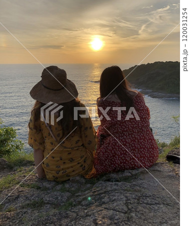 A fiery and vibrant sunset casts a mesmerizing and dramatic sky over the tranquil expanse of the sea, painting the horizon with stunning hues of orange, pink, and purple. 120031254