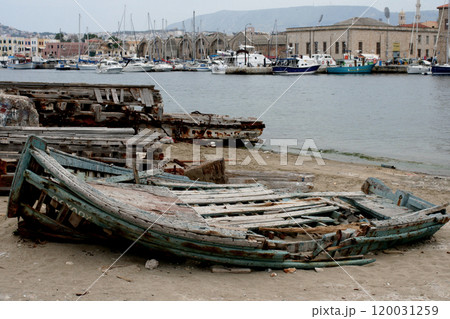 old ruined wooden boat on the shore near the water 120031259