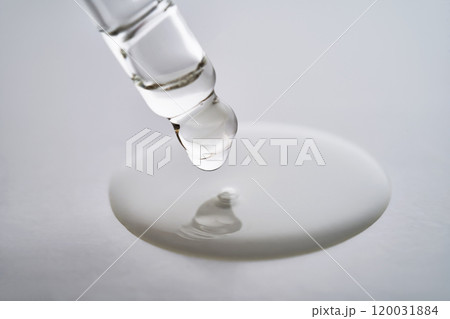 Dropper pipette with delicious serum with drop close-up. Dropper pipette with delicious serum with drop close-up. 120031884