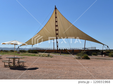 Beige sun shade against the backdrop of the desert 120031968