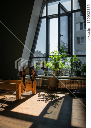 Modern Pilates studio with bright, spacious windows for exercise and wellbeing 120032356