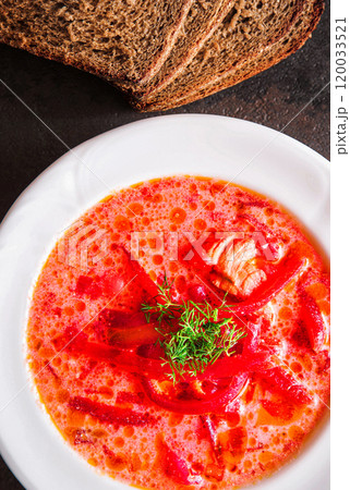 Homemade red beetroot soup on black stone slate background. Traditional Ukrainian borscht with sour cream Homemade red beetroot soup on black stone slate background. Traditional Ukrainian borscht with sour cream 120033521