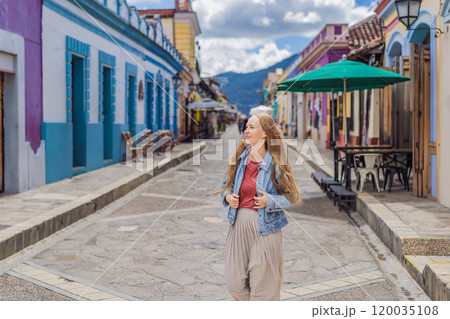 Female tourist walks through the colonial streets San Cristobal de las Casas, Mexico. Cultural exploration, architecture, and travel experience concept 120035108