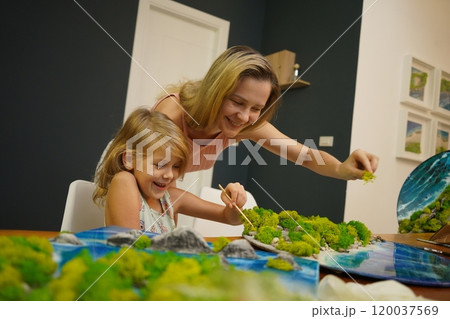 A mother and her daughter craft vibrant natural landscapes A mother and her daughter craft vibrant natural landscapes 120037569