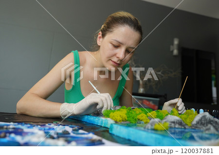 The process of making the art decor of epoxy resin, natural stones and moss 120037881