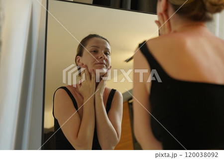 A young woman is enjoying a wonderfully serene morning in her bedroomnd A young woman is enjoying a wonderfully serene morning in her bedroomnd 120038092