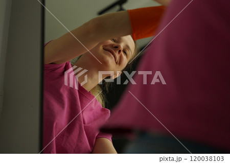 A woman is cleaning her living room at home A woman is cleaning her living room at home 120038103