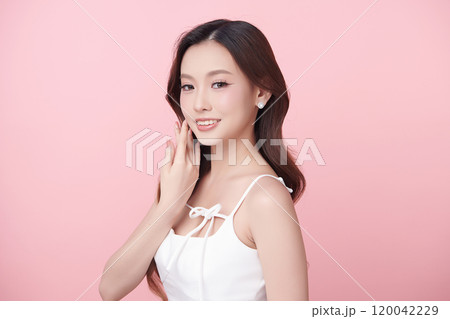 Beautiful young asian woman with clean fresh skin on pink background, Face care, Facial treatment, Cosmetology, beauty and spa, Asian women portrait. Beautiful young asian woman with clean fresh skin on pink background, Face care, Facial treatment, Cosmetology, beauty and spa, Asian women portrait. 120042229