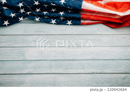 Veterans Day celebration concept, American flags on wooden background, symbolizing honor, pride, and democracy. November 11 is a day to honor our veterans. 120042684