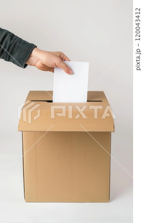 Civic duty - hand placing a ballot paper in ballot box for voting, emphasizing importance of election concept, showcasing anonymity of secret ballot, reflecting competitive nature of preelection race. 120043412