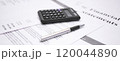 Financial statement review with calculator and pen emphasizing numbers and data analysis 120044890