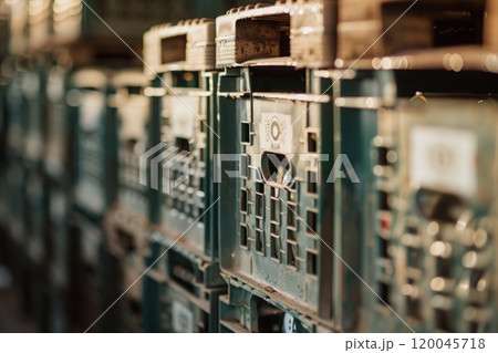 A row of stacked green plastic crates. 120045718