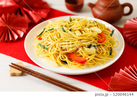 Chinese Lunar New Year concept with lucky food longevity noodles on wooden table background. Chinese Lunar New Year concept with lucky food longevity noodles on wooden table background. 120046144