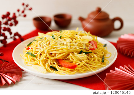 Chinese Lunar New Year concept with lucky food longevity noodles on wooden table background. 120046146