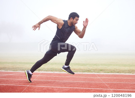 Outdoor, fitness and man running at track for sports, exercise and practice for competition. Fog, mist and Asian male athlete with speed at athletics field for workout, cardio and training for race 120048196