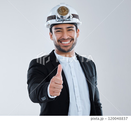 Man, thumbs up and coin on helmet for cryptocurrency in studio portrait, happy and fintech by white background. Person, smile and mining gear for blockchain, trading and money for financial freedom 120048837