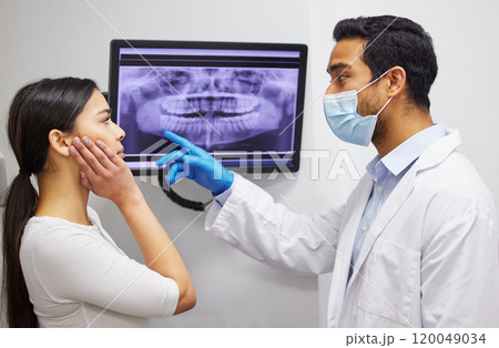 Dentist, communication and x ray of teeth on screen for patient education, dental diagnosis and treatment planning. Oral assessment, person and monitor for mouth scan for hygiene, health and wellness 120049034