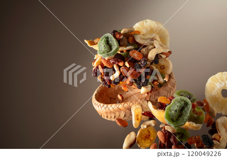 Dried tropical fruits with various nuts and raisins in motion. Dried tropical fruits with various nuts and raisins in motion. 120049226