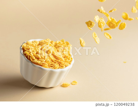 Dry honey cornflakes in a ceramic plate. 120049238