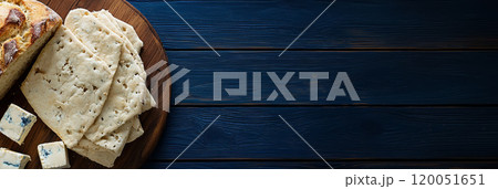 Top view of Lori traditional bread and a variety of homemade cheeses on a wooden surface 120051651