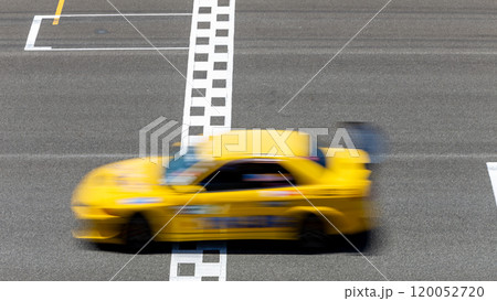 Motion blur race car racing on speed track, Car race on the international circuit race track crossing start and finish line, Race car crossing start and finish line, Target business achieve victory. 120052720