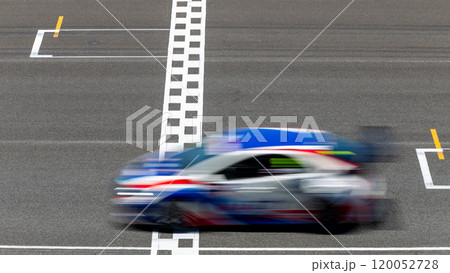 Motion blur race car racing on speed track, Car race on the international circuit race track crossing start and finish line, Race car crossing start and finish line, Target business achieve. 120052728