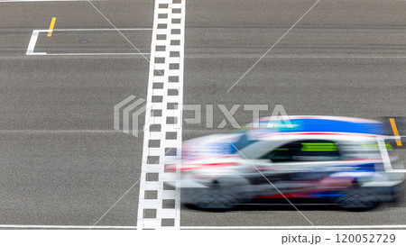 Motion blur race car racing on speed track, Car race on the international circuit race track crossing start and finish line, Race car crossing start and finish line, Target business achieve. 120052729