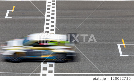 Motion blur race car racing on speed track, Car race on the international circuit race track crossing start and finish line, Race car crossing start and finish line, Target business achieve. 120052730