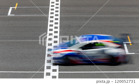 Motion blur race car racing on speed track, Car race on the international circuit race track crossing start and finish line, Race car crossing start and finish line, Target business achieve. 120052731