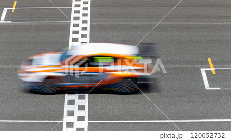 Motion blur race car racing on speed track, Car race on the international circuit race track crossing start and finish line, Race car crossing start and finish line, Target business achieve. 120052732