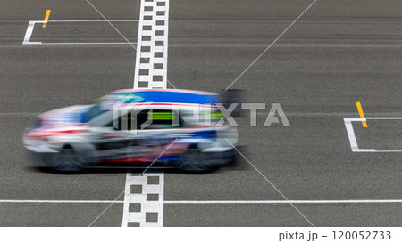 Motion blur race car racing on speed track, Car race on the international circuit race track crossing start and finish line, Race car crossing start and finish line, Target business achieve. 120052733